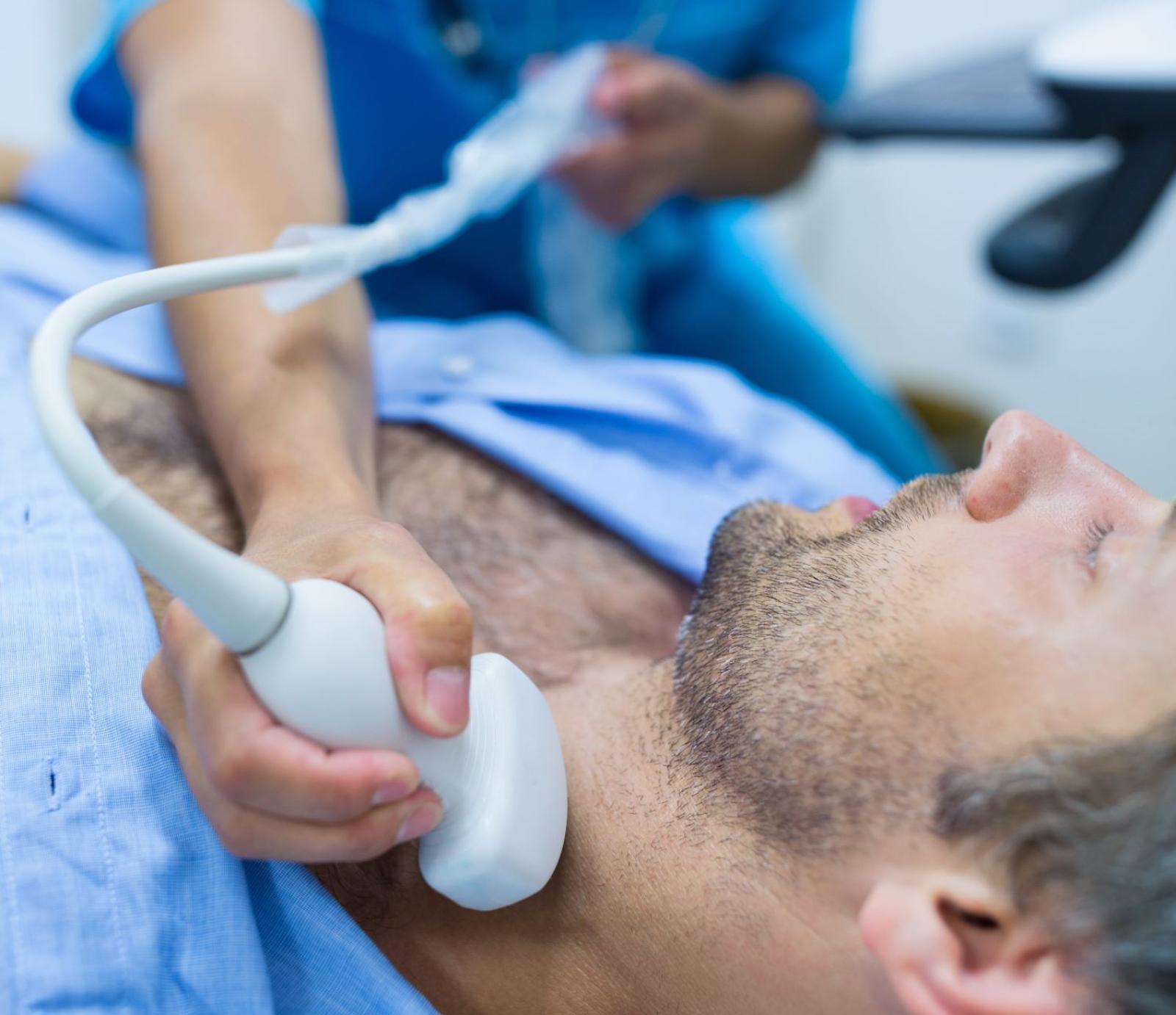 man-getting-ultrasound-thyroid-from-doctor